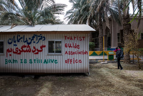 کانکس متعلق به دفتر انجمن راهنمایان گردشگری بم است که روی آن به انگلیسی نوشته شده: بم زنده است.